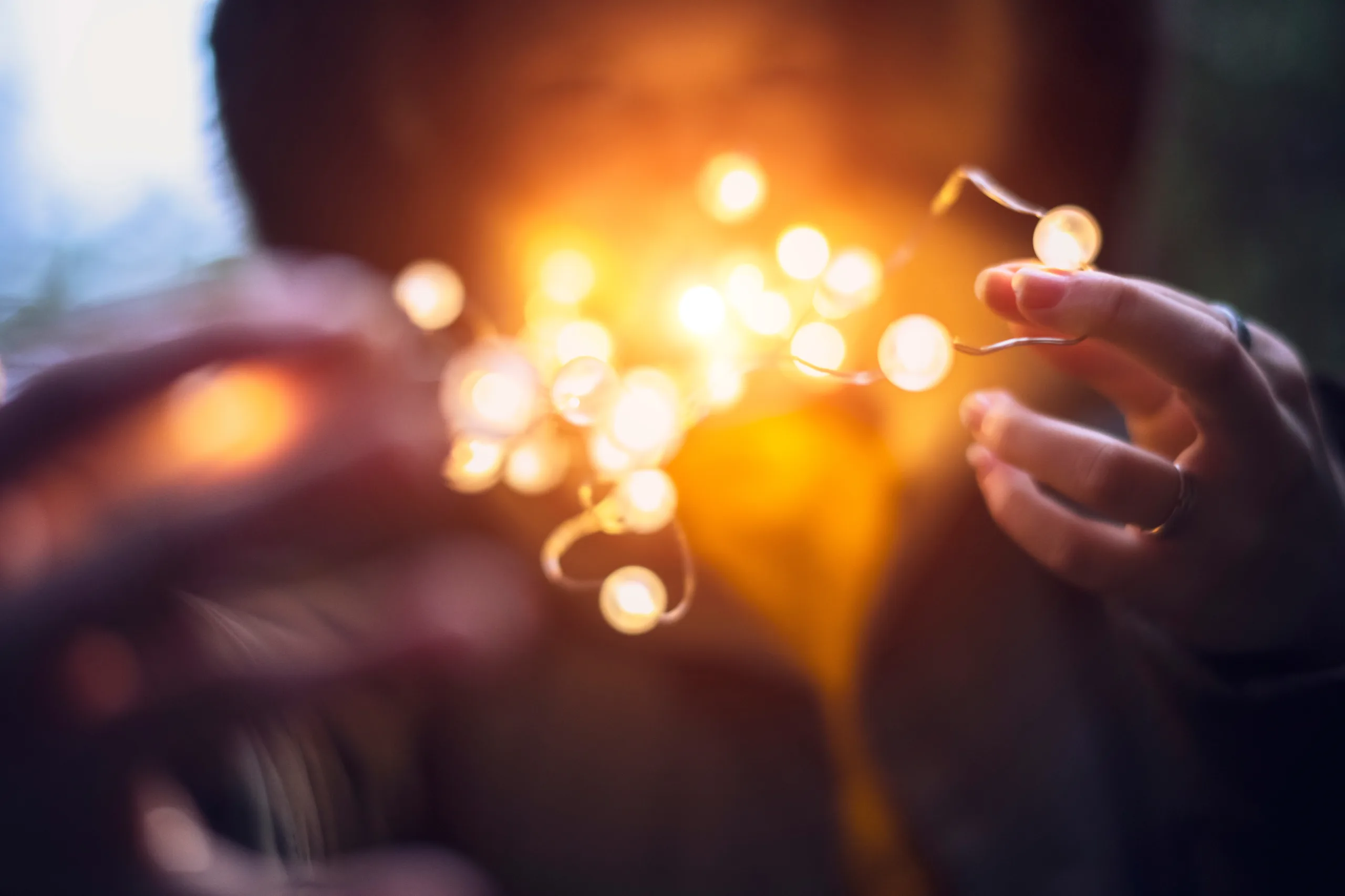 Woman holding bright string lights